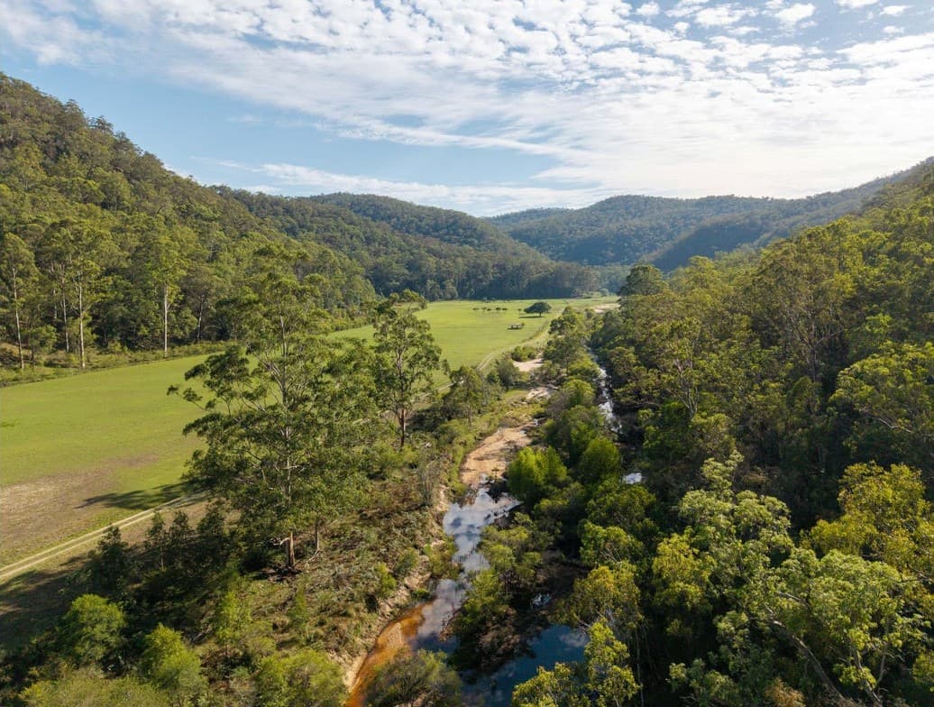 Aerial of the creek winding beside the open flats