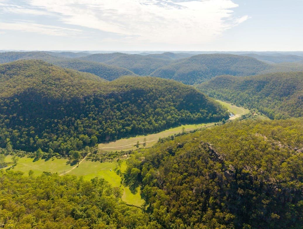 Forested sandstone ridges receding to the horizon